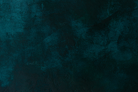 texture old stone concrete wall dark green color with cracks , backgroundの写真素材