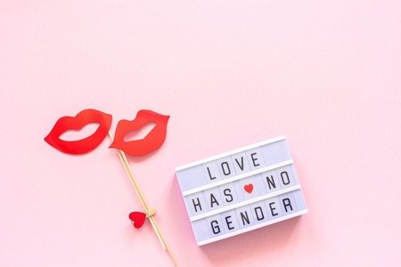 Lightbox text Love has no gender, couple paper lips props on pink background. Concept Homosexuality lesbian love National Day Against Homophobia or International Gay Day Top view Greeting card.の写真素材