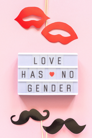 Lightbox text Love has no gender, couple paper mustache lips props on pink background. Concept Homosexuality gay love National Day Against Homophobia or International Gay Day Top view Greeting card.の写真素材
