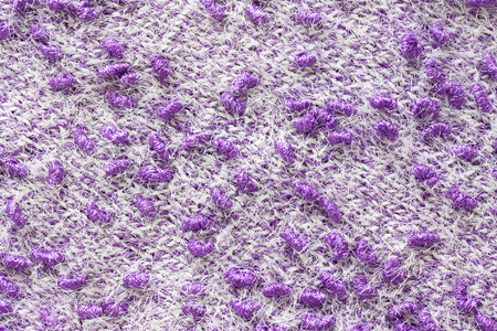 Texture of the knitted fabric. Knitting from yarn, handmade. A pattern of color white and purple yarn, background.の写真素材