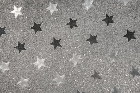 Silver wrapping paper, flickering star shape pattern as background or texture.の写真素材