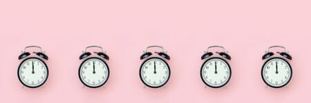Banner with black alarm clock on pink background. Minimal style Top view Template for your text, design.の写真素材