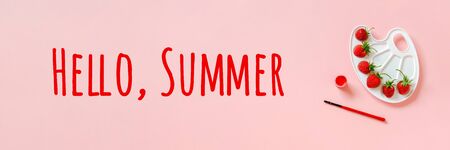 Hello summer texn Red ripe strawberries on artistic palette, brush and gouache on pink background Creative concept summer colors paint.の写真素材
