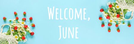 Welcome June text. Bouquet of white chamomile in reusable shopping eco mesh bag and splash red...