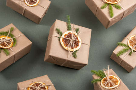 Flying Christmas and New Year gifts. Craft paper boxes decorated with dried oranges, spruce branches...