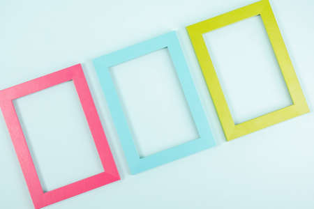 Creative layout made of three bright colored frames on blue background. Flat lay Top view Copy space Mockup.の写真素材