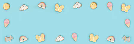 Summer banner made with funny cookie gingerbread on blue background. Top view Flat lay Copy space.の写真素材