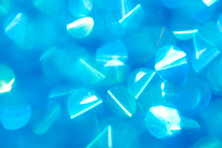 Beautiful abstract pattern with blue festive bokeh. Bright blurred background. Defocus texture of celebration glitter decor.の写真素材