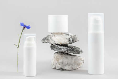 Set of cosmetic for skin care face, body. White blank cosmetics bottles, jar and stones on gray background. Natural Organic Spa Cosmetic Beauty Concept Mockup Front view.の写真素材