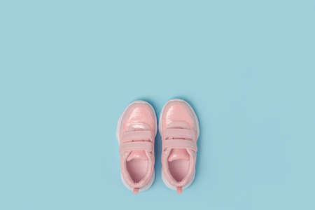 Sports shoes, sneakers on blue background. Sport lifestyle concept Top view Flat lay Copy space.の写真素材