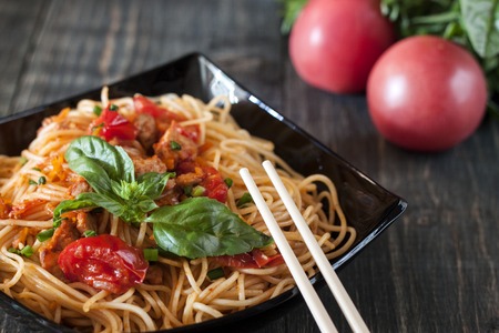 Spaghetti in tomato sauce with chickenの写真素材