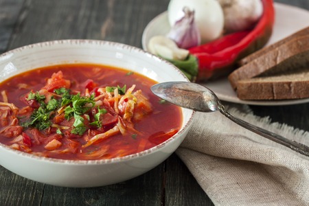 Ukrainian borscht in a plate on a wooden tableの写真素材