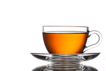 Cup of black tea and spoon, isolated on whiteの写真素材