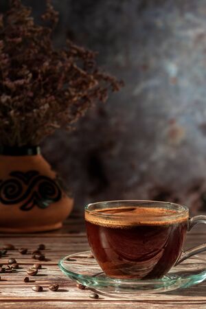 Cup of fresh aromatic coffee on a wooden tableの写真素材