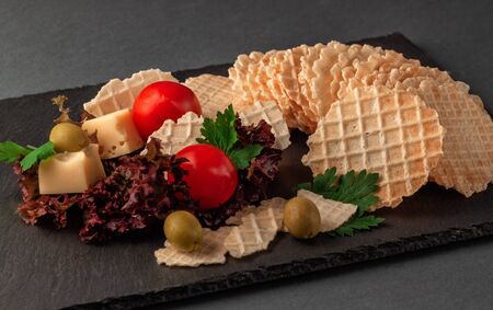 Crispy wafers made of wheat flour on a serving plate with lettuceの写真素材