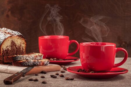 On the table are two cups of freshly brewed coffee.の写真素材