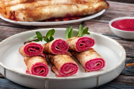 Pancakes with beetroot and cheese pasta and salmonの写真素材