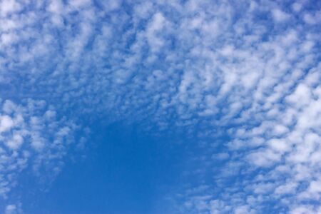 On a clear blue sky cumulus clouds
