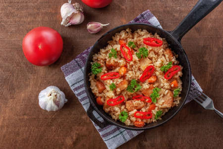 Rice with meat, vegetables and parsley in a portioned panの写真素材