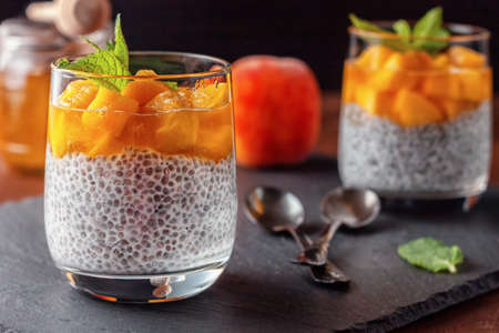 Chia pudding with coconut milk, fresh peaches and honey. Vegan healthy food.の写真素材