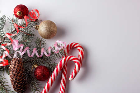 Fir tree branches, red decorations on white background. Christmas composition. Christmas, winter,...