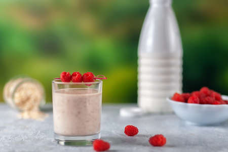 Oatmeal milkshake with bananas and raspberries. Healthy diet food