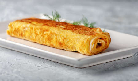Japanese kitchen. Tamagoyaki - Japanese omelet, rolled several layers of fried eggの写真素材