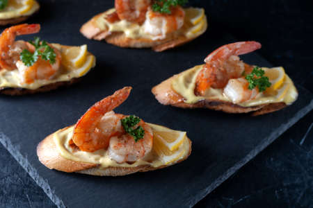Bruschetta with shrimps, mayonnaise and micro greens. Healthy eating conceptの写真素材