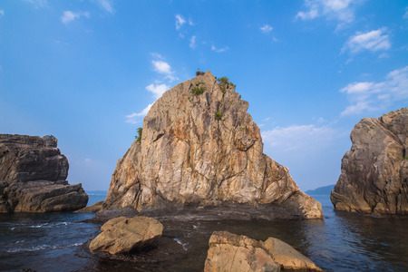 Huge rocks standing on the shore in Japanの写真素材
