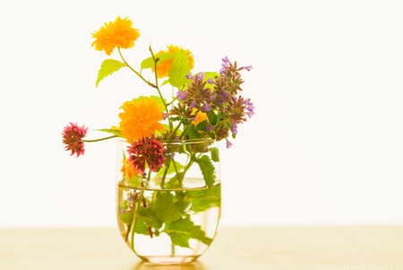 spring flowers in a glass vase on a table