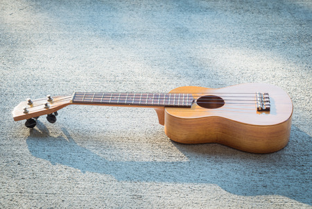 ukulele on a concrete floor