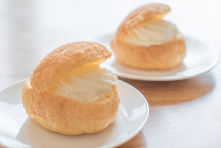 Cream puff on wooden tableの写真素材