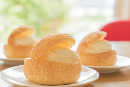 Cream puff on wooden tableの写真素材