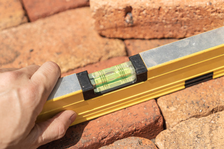 Worker using level tool.