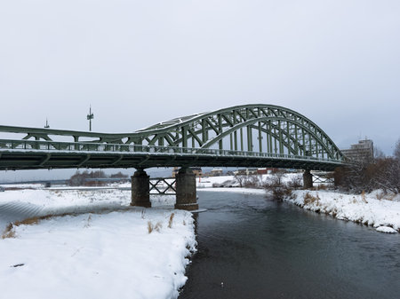 Asahibashi Bridge in Asahikawa, Hokkaido, covered in winter snow over the Ishikari Riverの写真素材