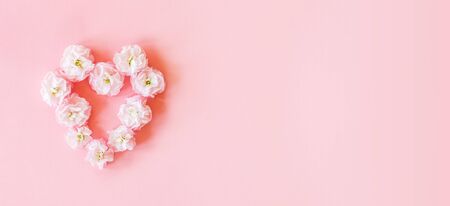Close up of pink heart made of matthiola flowers on pink background. Flower arrangementの写真素材