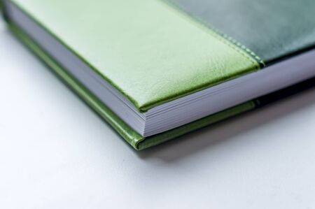 angle of green note book lying on the tableの写真素材