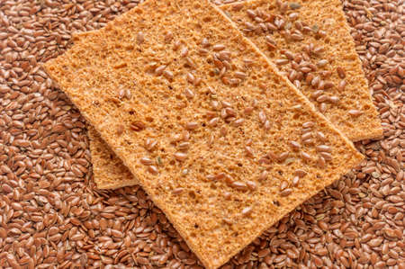 flax seeds and two slices of rye bread background