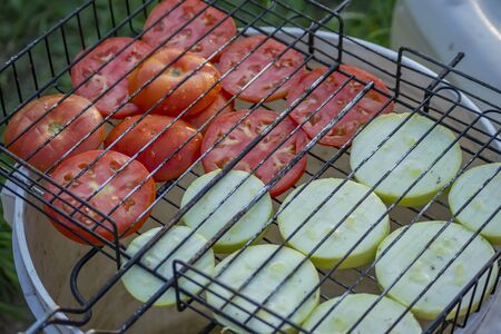 Charcoal grill with vegetables. zucchini and tomatoes.の写真素材