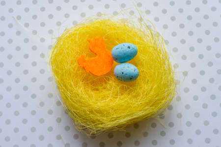 Artificial easter nest with two eggs and cockの写真素材