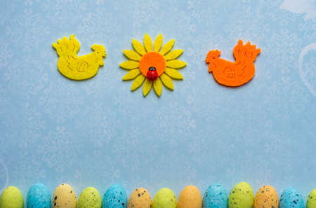 Background two cocks, sunflower with ladybug and eggsの写真素材