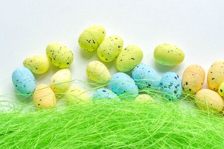 Artificial grass with colored eggs backgroundの写真素材
