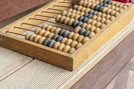 Old wooden abacus on wooden background. Close-up.の写真素材