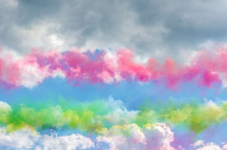 Colorful smoke in blue sky with clouds