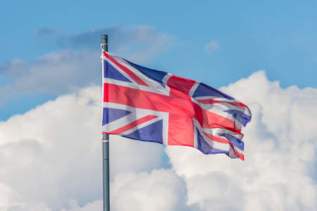 The National flag of United Kingdom flay over the blue skyの写真素材