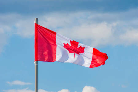The National flag of Canada flay over the blue skyの写真素材