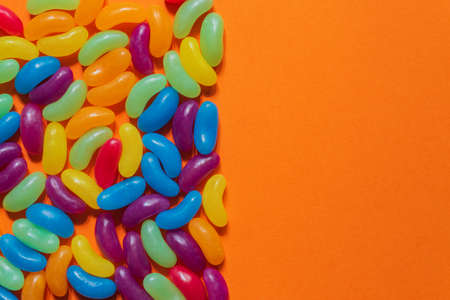 Assorted Jelly Beans border with copyspace on orange background.の写真素材