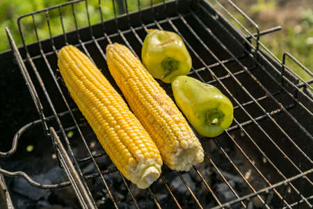 closeup of corn and paprika on grillの写真素材