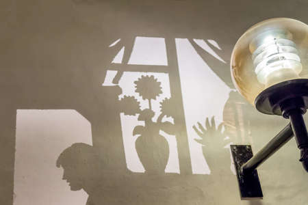 painted shadow of window on the wall. Lightning lampost on the wall