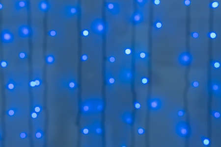 Decorative blue LED lights on wires - Defocused backgroundの写真素材